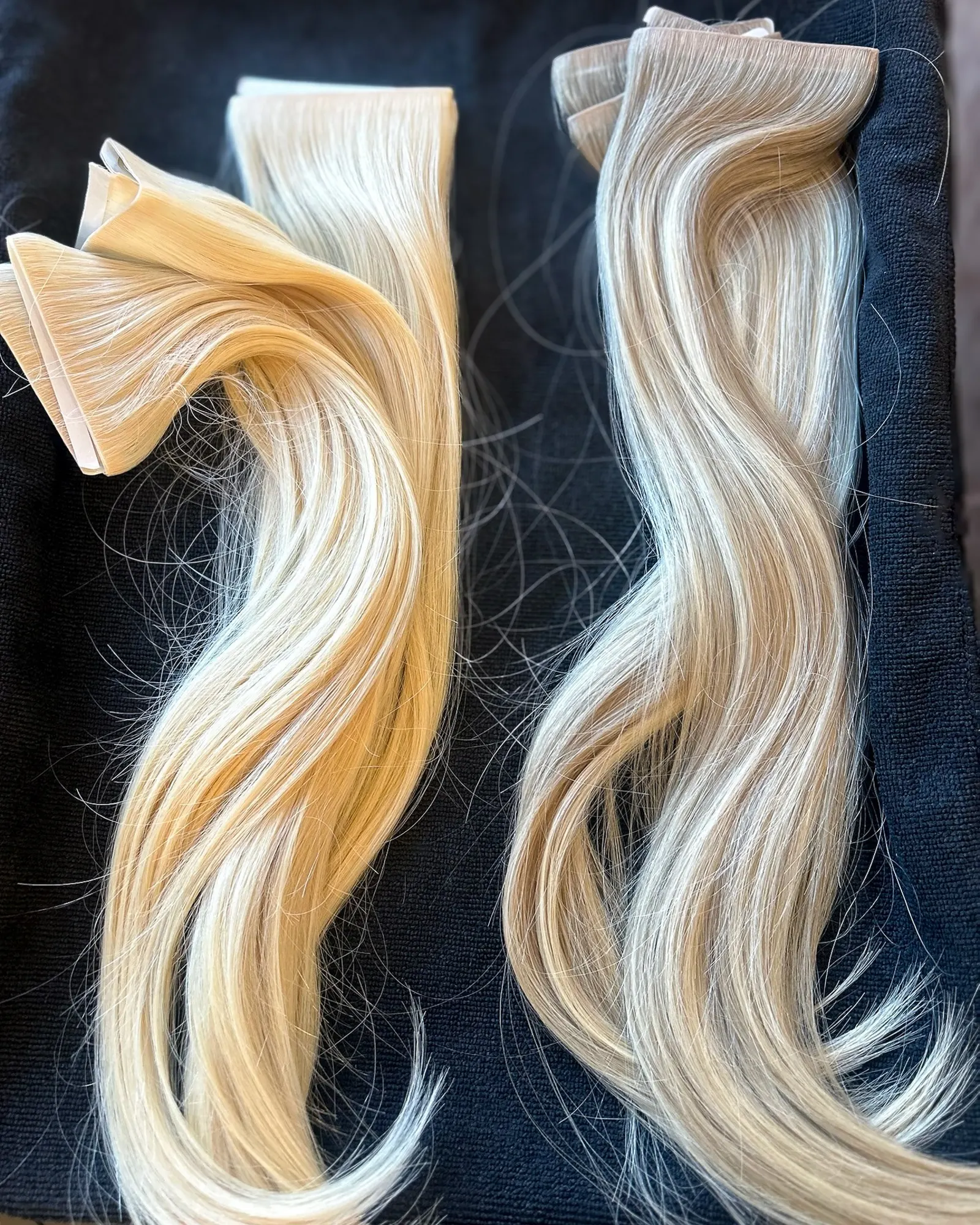 Two different extension wefts laid side by side on black, one straight and one waved.